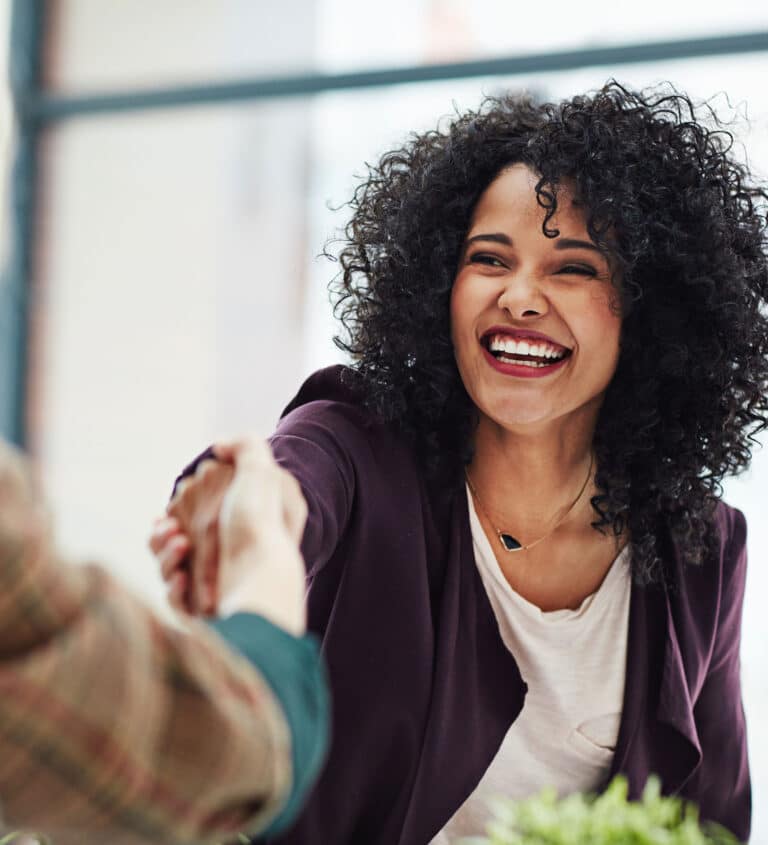 Handshake with a happy, confident and excited business woman