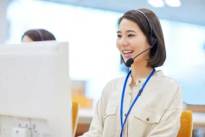 Customer service professional assisting customers while working at a computer workstation