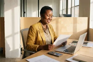 Office professional reviewing documents at a desk in an administrative work environment